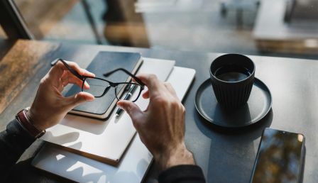 Entrepreneur sitting at ta table with notebooks and smartphone