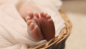 Baby's Feet on Brown Wicker Basket