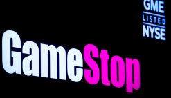 A screen displays the logo and trading information for GameStop on the floor of the New York Stock Exchange (NYSE) in New York City, U.S., March 29, 2022.
